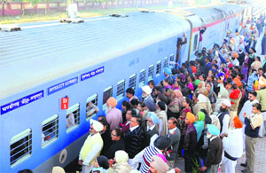 Passengers board the train at the Mohali railway station on Friday. T