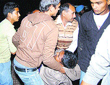 Local residents help in rescue operations after a truck carrying pilgrims overturns near Chappar in Yamunanagar on Friday