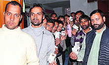 Youth Congress voters display their voter cards in Mandi on Friday