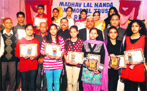 The Chief Guest, students and the organisers, after the function to felicitate students in Reasi on Thursday