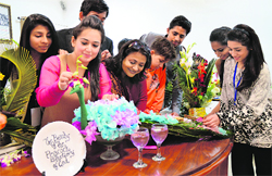 Students from Pakistan give the finishing touches to a flower arrangement during the Inter-School Youth Festival at BCM School in Ludhiana. Photo: Inderjeet Verma