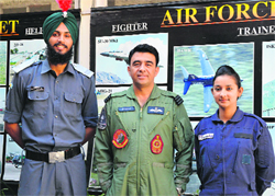 Cadet Priyanka and Gurlal Singh Sandhu accompanied by Wing Commander SS Kaila, Commanding Officer of the unit, during the felicitation function in Ludhiana. Photo: Inderjeet verma
