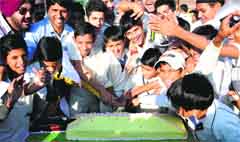 Budding cricketers cut a cake in honour of Sachin Tendulkar at the Sector 16 stadium in Chandigarh on Saturday. Tribune photo: Manoj Mahajan