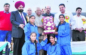 Players of the Sangrur team lift the Swamy Vivekanands State Rural Games (Girls) trophy in Jalandhar on Saturday