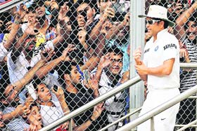 Sachin walks down to the field on the final day of his last Test in Mumbai on Friday