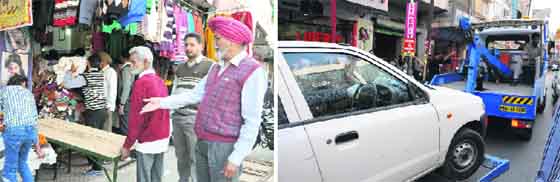 An unauthorised vend being removed at Dhobi Bazaar in Bathinda on Sunday; and (right) a traffic police vehicle tows away a wrongly parked car. Photos: Bhupinder Dhillon