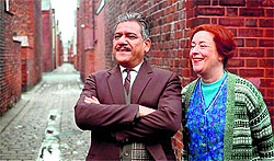 Om Puri as George Khan and his English wife Ella Khan (Linda Bassett) in East is East.