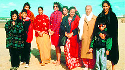 Bhaji on the Beach Asian women in their attire of the 60s on a beach in the UK.