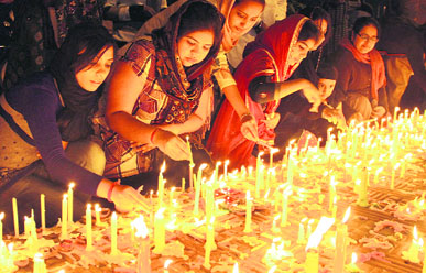 Devotees light candles outside a gurdwara on Gurpurb at Model Town in Jalandhar on Sunday evening.