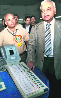 Deputy Election Commissioner Alok Shukla demonstrates the voter-verified paper audit trail that is being introduced for the first time during the Delhi Assembly poll, in New Delhi on Sunday. 