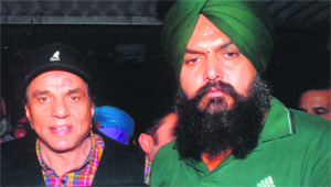 Dharmendra with Amritpal Singh, sarpanch of Dango village. 