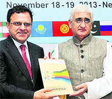 Dr Hazrat Omar Zakhilwal (L), Minister of Finance, Afghanistan, and External Affairs Minister Salman Khurshid release a paper on 'Doing business with Afghanistan' during a seminar at Ficci in New Delhi on Monday