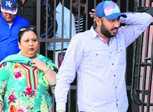 The wife and son of Manjit Singh Arora come out of the judicial complex on Monday. 