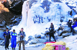 Tourists enjoy snow near the Rahla waterfall on the Manali-Rohtang road on Sunday. Photo: MC Thakur