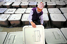 An official checks the ballot boxes before they are distributed to the polling stations in Kathmandu