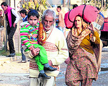 An elderly and women walk a long distance with luggage during the BSP workers protest at PAP Chowk