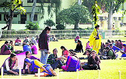 Students of a college bask in the sun in Jalandhar on Tuesday