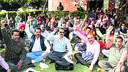 Members of the Punjab State Aided School Teachers and other employees union stage a protest at the DC office in Jalandhar on Tuesday