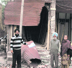 Jaswinder Singh Bhullar showing the demolished part of a hotel in Amritsar on Wednesday. 