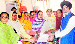 Mid-day meal cooks submit a memorandum to Education Minister Sikander Singh Maluka In Bathinda on Wednesday