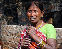 A woman cries as the UT staff demolish her house
