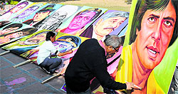 Artists paint posters of Bollywood actors for the Chandigarh Carnival on Wednesday