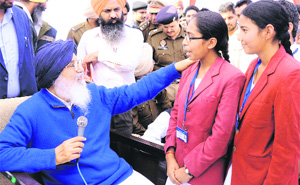 Chief Minister PS Badal honours meritorious students during his Sangat Darshan in Lambi on Wednesday. 
