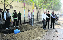 Paras Ram Nagar residents show pothold roads on Thursday. Photo: Bhupinder Dhillon 