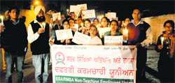 Members of the SSA/RMSA hold a candlelight march in Bathinda on Thursday. Photo: Bhupinder Dhillon