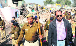 Deputy Commissioner Mohammed Shayin oversees the demolition drive in Colony No. 5 in Chandigarh on Thursday. Tribune photo