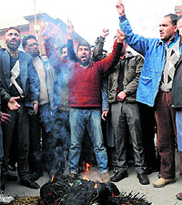 Employees of the Jammu and Kashmir Urban Local Bodies Employees United Forum protest against the state government in Srinagar on Thursday