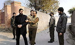 Police officials stop Hurriyat Conference spokesperson Ayaz Akbar outside Syed Ali Geelanis residence at Hyderpora on Thursday