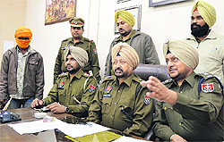 Police officials address a press conference with the accused (with face covered) in Ludhiana on Thursday