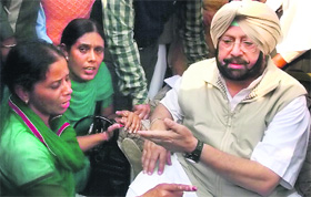 A woman complains to Capt Amarinder Singh against a SAD worker in Moga on Thursday.