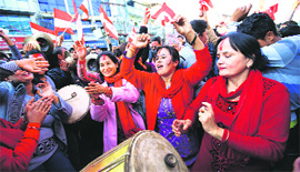 Supporters of Nepali Congress Party cheer for their party as Constituent Assembly Elections scores are displayed on a screen outside the Assembly building in Kathmandu on Thursday.