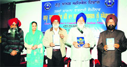 Avtar Singh Makkar (second from right), Prof Ajaib Singh Brar (second from right), Vice-Chancellor, releases a book on the occasion of the seminar on Guru Nanak Dev in GNDU, Amritsar, on Friday. A Tribune photograph 