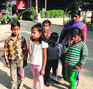 A resident of Colony No. 5 with her children who have not received school-leaving certificates from Government Model Sr. Sec. School, Sector 45.