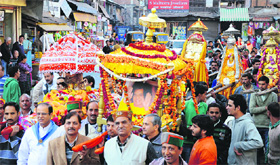 Devotees participate in palki utsav on the eve of the birth anniversary of Sri Sathya Sai Baba in Mandi on Friday.
