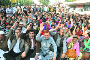 Members of the J&K National Trade Union Front protest in Jammu on Friday. 