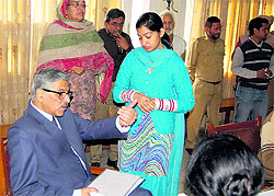Justice Rajive Bhatia, Judge, Punjab and Haryana High Court, and Administrative Judge, meets people during the National Lok Adalat at District Amritsar