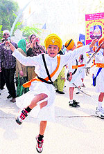 Children perform gatka during nagar kirtan in Amritsar on the eve of martyrdom day of Guru Teg Bahadur on Saturday