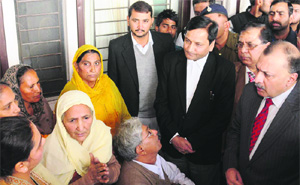 Judicial officials interact with litigants during a Lok Adalat in Chandigarh on Saturday. 