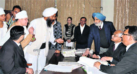 Judges hear a case during a Lok Adalat at the District Sessions Court in Jalandhar on Saturday.