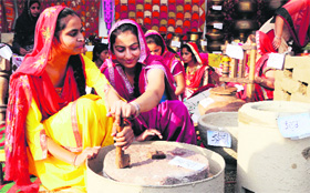 Students construct a rural setting during the 44th Foundation Day celebrations of GNDU in Amritsar on Sunday.