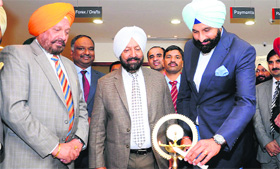 Revenue Minister Bikram Singh Majithia (right) and Amarjit Singh Samra (left) inaugurate a branch of Capital Local Area Bank in Amritsar on Sunday.