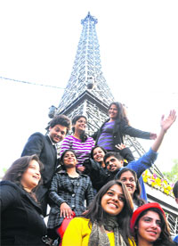 Students strike a pose against the backdrop of a replica of Eiffel Tower during Chandigarh Carnival on Sunday