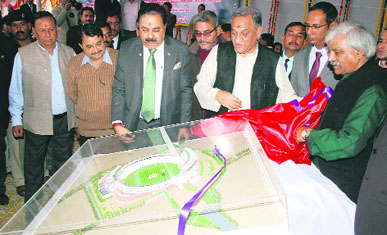 Chief Minister Vijay Bahuguna and ONGC Chairman-cum-MD Sudhir Vasudeva have a look at the model of Rajiv Gandhi International Cricket Stadium at Raipur near Dehradun on Sunday.