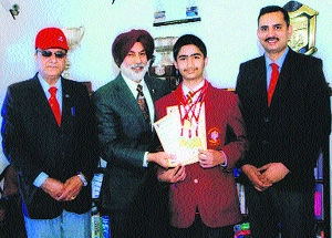 Dalhousie Public School Director and Principal Dr (Capt) GS Dhillon felicitates Kumar Kartikay for getting four gold medals. 