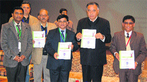 State technical education Minister GS Bali releases an IOA souvenir at the DRPGMC in Tanda on Sunday. 