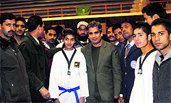 Tae kwon do players with the officials of the sports club at the Indoor Stadium in Srinagar on Sunday